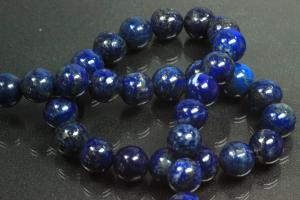 Lapis Lazuli spherical gemstone strand blue, approx. dimensions  10mm, approx. 39,5cm long. Quality feature A. This gemstone strand was provisionally strung on blue pearl silk for further processing.
