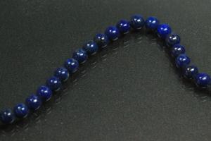 Lapis Lazuli spherical gemstone strand blue, approx. dimensions  4mm, approx. 39,5cm long. Quality feature A. This gemstone strand was provisionally strung on blue pearl silk for further processing.