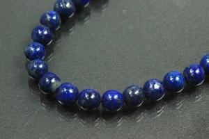 Lapis Lazuli spherical gemstone strand blue, approx. dimensions  6mm, approx. 39,5cm long. Quality feature A. This gemstone strand was provisionally strung on blue pearl silk for further processing.