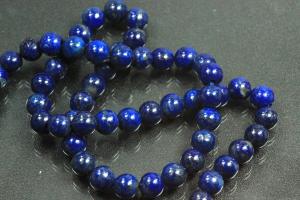 Lapis Lazuli spherical gemstone strand blue, approx. dimensions  6mm, approx. 39,5cm long. Quality feature A. This gemstone strand was provisionally strung on blue pearl silk for further processing.